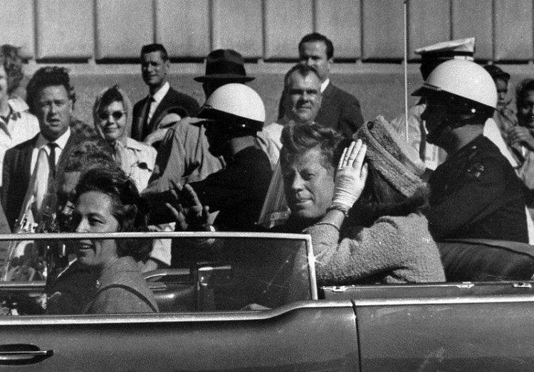 President John F. Kennedy is seen riding in motorcade approximately one minute before he was shot in Dallas, Tx., on Nov. 22, 1963.