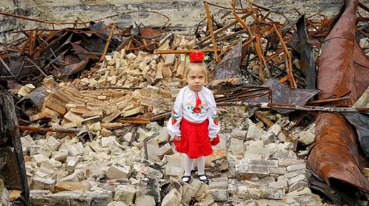 UNICEF. Olena Hrom A young girl stands in the rubble of her damaged school in Horenka, in the Kyiv region of Ukraine.