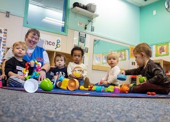 military families child care. A child development center staff member cares for children at Buckley Space Force Base, Co. Photo by Craig Z. Rodarte. DOD.