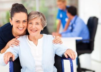Caring adult daughter accompanying senior mother visiting her doctor. Demonstration of senior care protection. Photo by Agile Mktg1. Flickr.