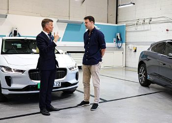 Discussing self driving vehicle in a test facility. Photo by Department of Transport. Gov.uk.