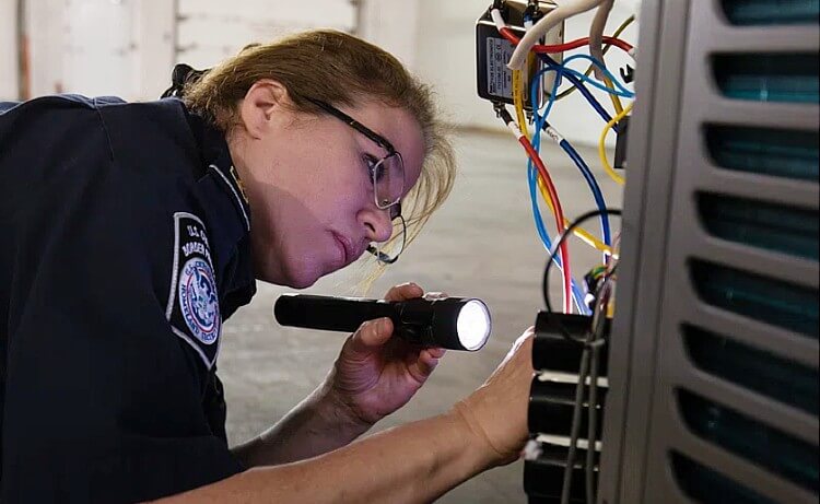 Customs and Boarder Patrol officer inspecting electrical equipment. Photo by the CBP. Rawpixel.
