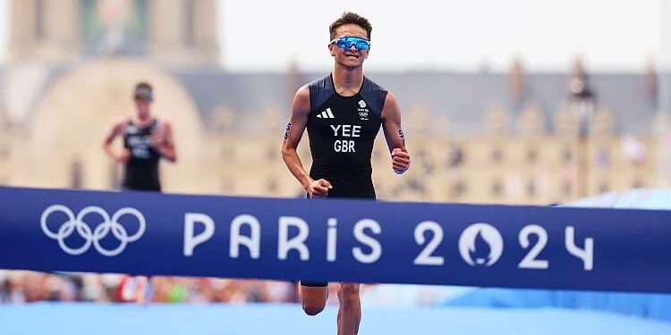Great Britain's Alex Yee crossing the line to win gold in the Parris 2024 Olympics Triathlon. Photo by Getty Images.