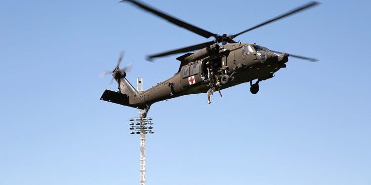 Members of the U.S. Army practice search and rescue techniques in a UH-60 Blackhawk helicopter. Photo by Cathryn Lindsay. Airforce, DOD.