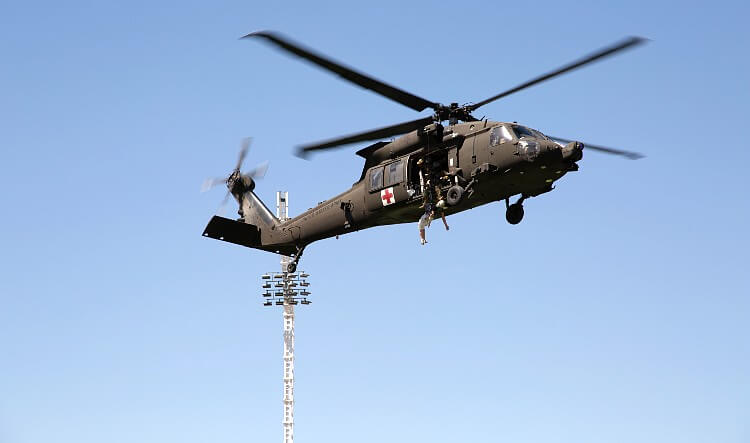 Members of the U.S. Army practice search and rescue techniques in a UH-60 Blackhawk helicopter. Photo by Cathryn Lindsay. Airforce, DOD.