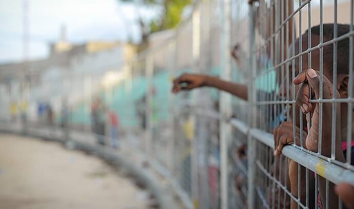 Young children behind a fence. Photo by AMISOM Public Information