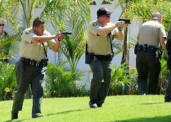 Police make arrests at gunpoint. Photo by Bush. Flickr.