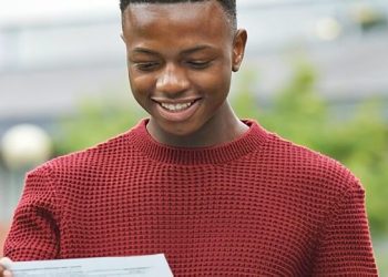 Teen with his A' level exam results. Photo by Department for Education. Gov.uk.