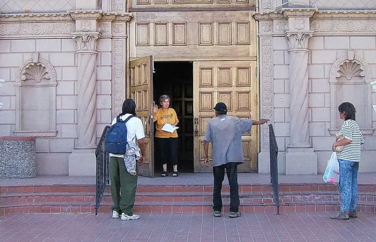 Joan Confronted by Homeless People. Photo by Tony Fischer Photography.