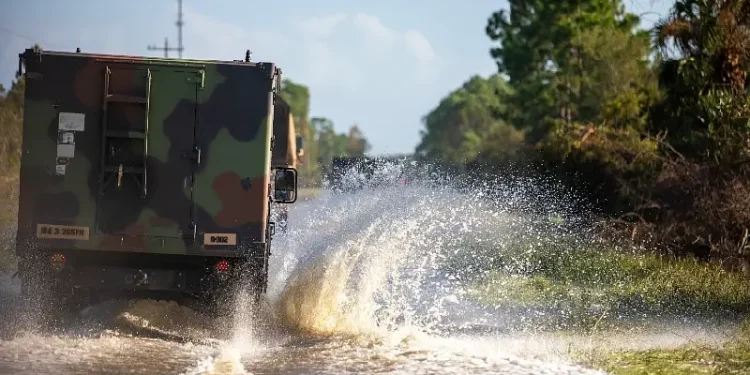 Military vehicles cause wake and waves while assisting law enforcement as part of their route clearing patrol in response to Hurricane Helene in Cedar Key, Fla., Sept. 27, 2024. Photo by DOD.