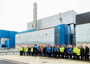 Some of the RER team in front of the encapsulation plants and product storage facilities on the Sellafield site. Photo by Sellafield Ltd.