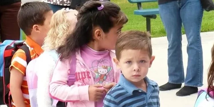 4 year old boy standing in line on first day of school. Photo by Lesley Show.