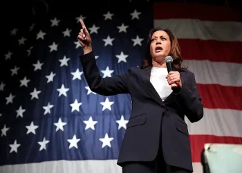 Kamala Harris speaking bout contraception coverage in from of the USA flag. Photo by Gage Skidmore.
