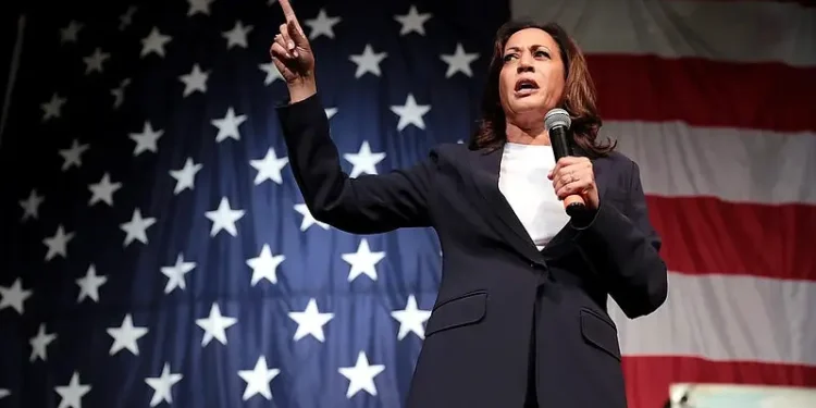 Kamala Harris speaking bout contraception coverage in from of the USA flag. Photo by Gage Skidmore.