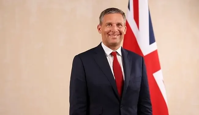 Official portrait of Lord Timpson - Minister of State. Photo by the UK Government.