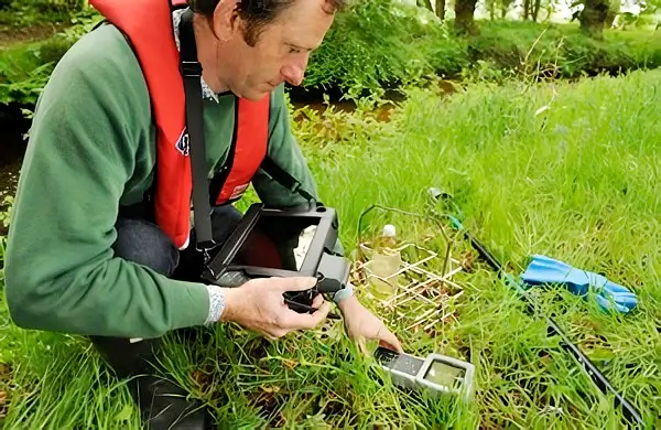 Environment Officer using electronic equipment. Photo by the Environment Agency.