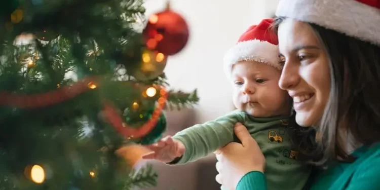 Mother and child at the christmas tree. Photo by HM Revenue & Customs.