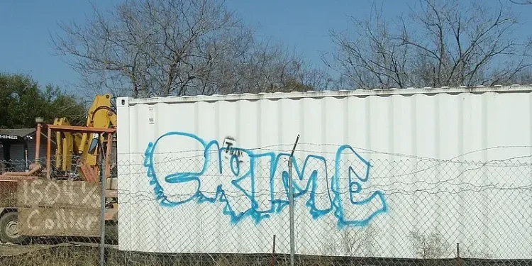 Crime written on a container. Photo by Tim Patterson.