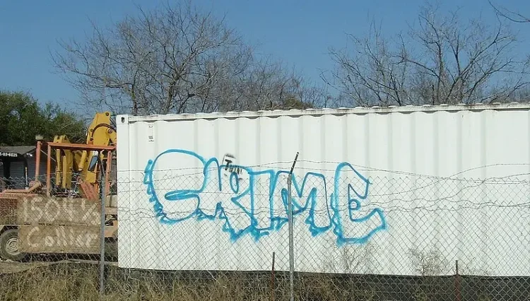 Crime written on a container. Photo by Tim Patterson.