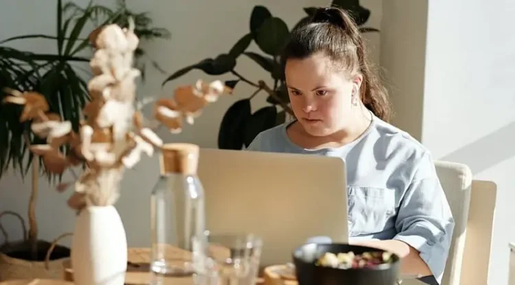 Young lady studying at her computer. Photo supplied by Ofsted.