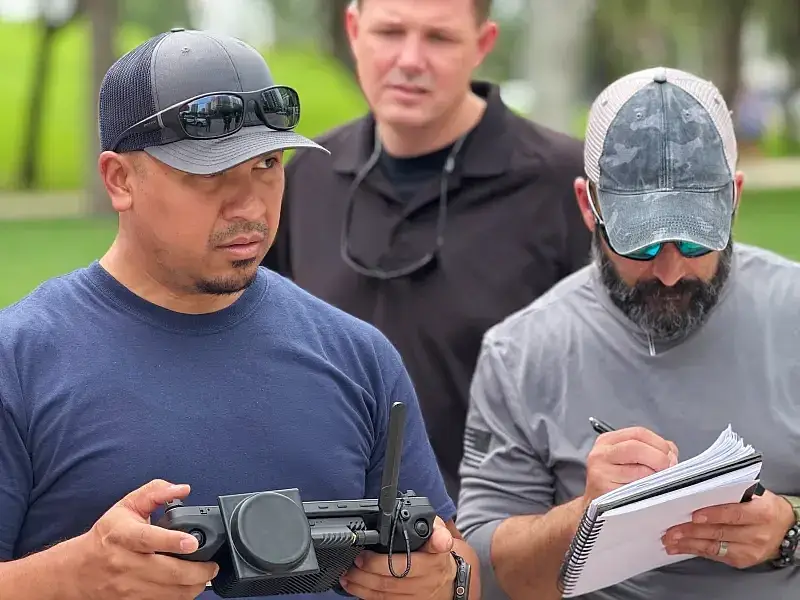 A first responder uses a GCS to fly an Ascent AeroSystems Spirit drone during a scenario-based flight and gives operational feedback to a DAGER Technology data collector. Photo by NUSTL.