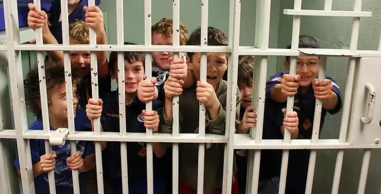 Cub scouts in a jail cell. Photo by Woodley Wonderworks.