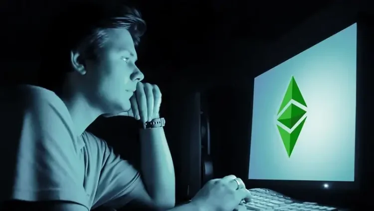 Man looking at a computer screen. The Darknet. Photo by EthereumClassic.