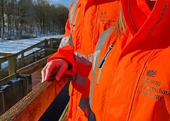 Official in a orange jacket. Photo by the Mining Remediation Authority.