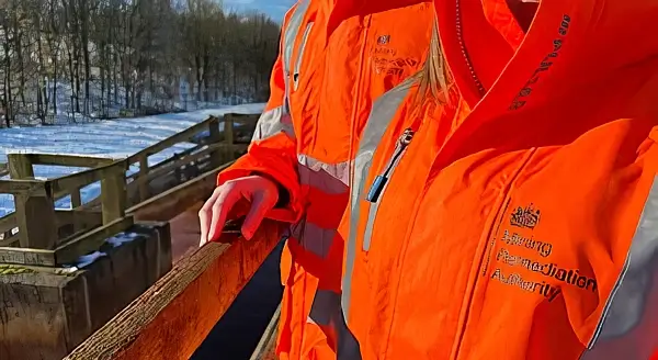 Official in a orange jacket. Photo by the Mining Remediation Authority.