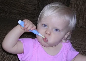 Toddler brushing his teeth. Photo by The Lamb Family.