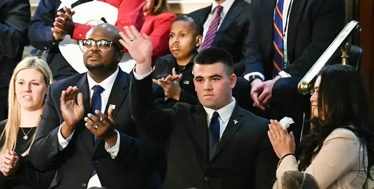 Upon learning of his acceptance to the United States Military Academy, high school student Jason Hartley waves to the crowd at Trump’s address to Congress. Photo by J Watson.
