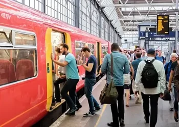 Commuters getting on a train. Photo by Department for Transport. **uk-stock-transport**