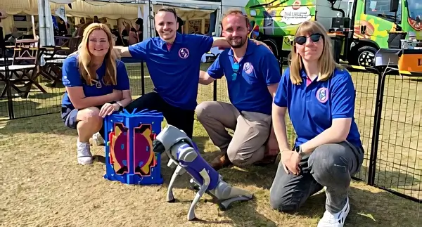 The STEP team pose with a robot dog. Photo by UK Industrial Fusion Solutions Ltd.