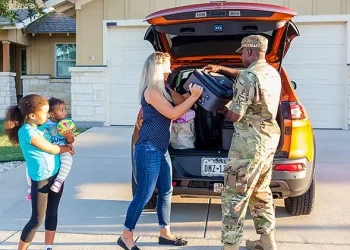 A family unloads their vehicle during a permanent change of station move, July 25, 2022. Photo by K. Hawkins.