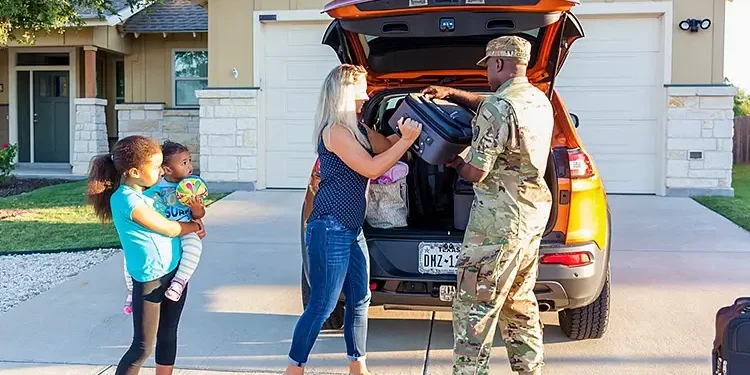 A family unloads their vehicle during a permanent change of station move, July 25, 2022. Photo by K. Hawkins.
