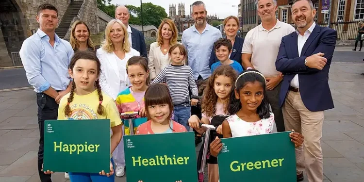 Chris Boardman, mayors and kids promoting new development. Photo by Active Travel England.