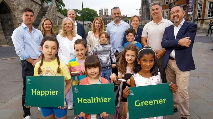 Chris Boardman, mayors and kids promoting new development. Photo by Active Travel England.
