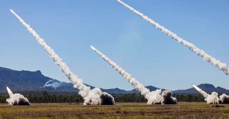 High Mobility Artillery Rocket Systems from the Australian army, the U.S. Army and the Singapore army fire rockets during live-fire exercise in Queensland, Australia, July 14. Photo by the ADF.