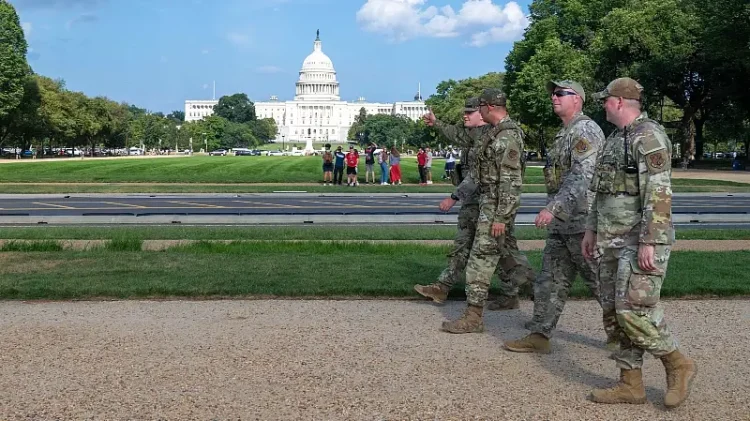 Airmen assigned to the D.C. Safe and Beautiful Task Force patrol in front of the U.S. Capitol in Washington, Aug. 16, 2025. The task force of 800 National Guard. Photo by Sgt Spraktes.