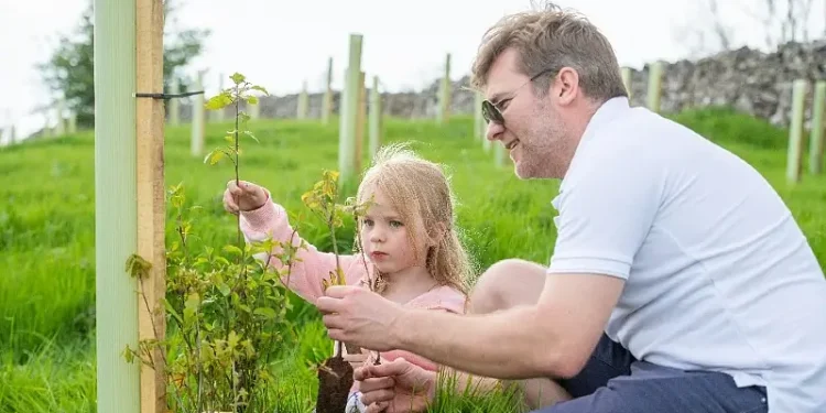 Members of the local community helping to plant the new woodland. Photo by IntroPR.