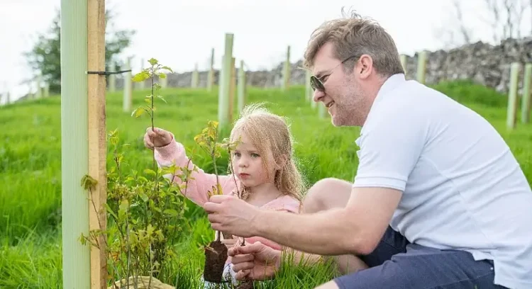 Members of the local community helping to plant the new woodland. Photo by IntroPR.