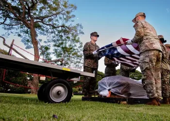 Service members assigned to the Defense POW-MIA Accounting Agency prepare to move a transfer case. Photo by Staff Sgt. Busby.