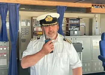 Captain Chris Phillips at the helm. Photo by the Department of Transport.