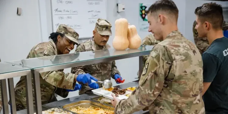 Army Col. Tanya Simmons serving Thanksgiving dinner. Photo by Army Sgt. Lopez.