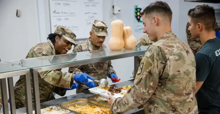 Army Col. Tanya Simmons serving Thanksgiving dinner. Photo by Army Sgt. Lopez.