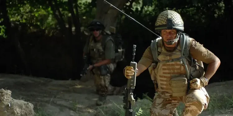 British Major in Afghanistan using a mobile radio. Photo by Resolute Support Media.