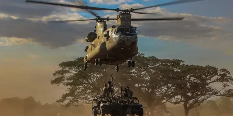 Soldiers assigned to the 2nd Battalion, 35th Infantry Regiment, 3rd Mobile Brigade, 25th Infantry Division, sling-load infantry squad vehicles to a CH-47 Chinook. Photo by Army Spec C. Moorehead.