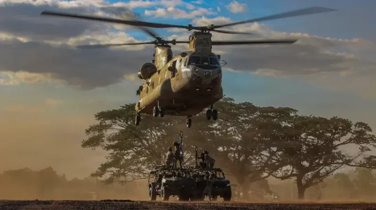 Soldiers assigned to the 2nd Battalion, 35th Infantry Regiment, 3rd Mobile Brigade, 25th Infantry Division, sling-load infantry squad vehicles to a CH-47 Chinook. Photo by Army Spec C. Moorehead.