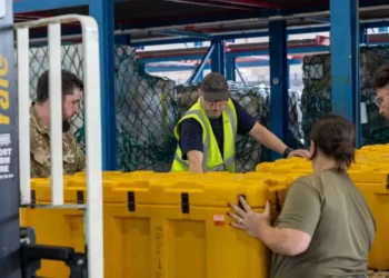RAF Movers from No.1 Air Mobility Wing build up pallets of humanitarian aid and specialist equipment. Photo by the MOD Crown Copyright.