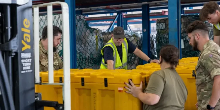 RAF Movers from No.1 Air Mobility Wing build up pallets of humanitarian aid and specialist equipment. Photo by the MOD Crown Copyright.